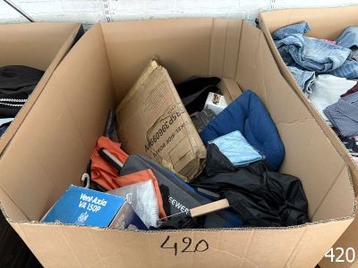 a cardboard box filled with clothes and other items