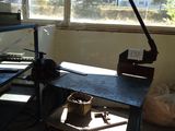 an image of a workbench in a room with a lot of clutter