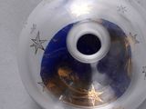 a glass vase with a blue star design on it