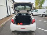 a white car with its trunk open in a parking lot