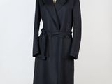 un manteau noir sur un mannequin sur fond blanc