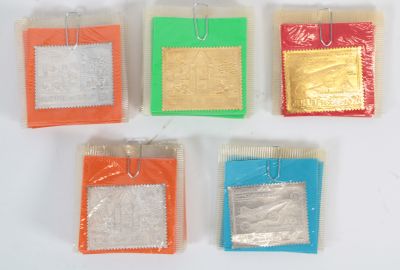 four different colored bags of candy sitting on top of a white surface