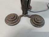a pair of old iron weights on a white table