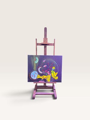 un petit chevalet sur lequel est posé un tableau, posé sur une surface blanche