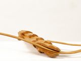 a wooden object that looks like a boat on a white surface