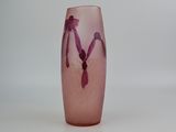 a pink glass vase with a purple design on it
