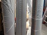 many rolls of aluminum foil sitting on the floor