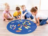 four children sitting on the floor playing with puzzles