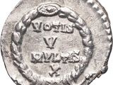 an old silver coin with a wreath on the front of it