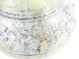 a close up of a vase on a white surface