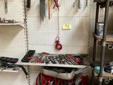 a workbench in a garage with many tools on it