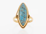 a gold ring with a turquoise stone in the center