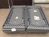 two plastic containers sitting on the ground next to each other
