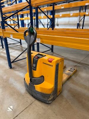 the forklift is parked in the warehouse with the pallet in the foreground