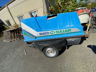 a small blue truck that is parked in front of a building