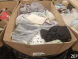 a cardboard box filled with clothes and other items