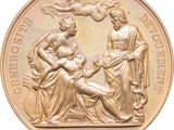 an image of a gold medal with a statue of a woman and a man