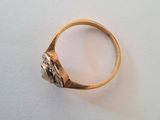an image of a gold ring with diamonds on a white surface