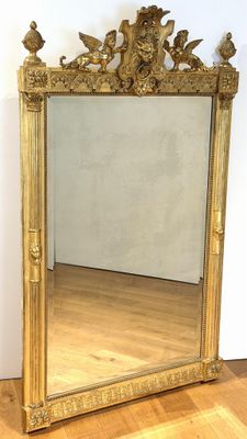 a mirror that is sitting on the floor in front of a wall