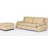a couch and ottoman in a room with a white background
