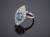 a blue sapphire and diamond ring on a black surface