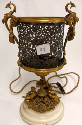 a gold vase on a white pedestal with a tag on it