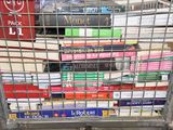 a metal cart with many books stacked on top of it