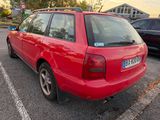 a red car that is parked in a parking lot