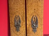 two wooden doors that are next to a red wall