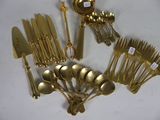 a lot of silverware on a white table