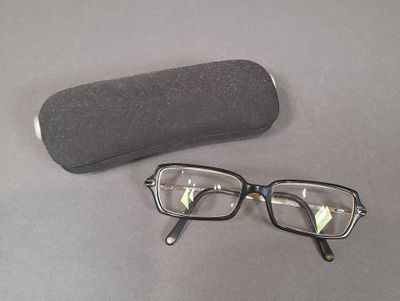 a pair of glasses and a case sitting on a table