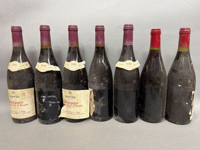 six bottles of wine are lined up in a row on a table