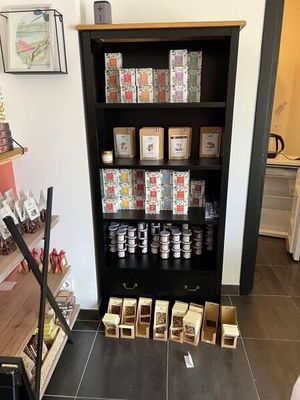 a black bookcase filled with lots of different types of goods
