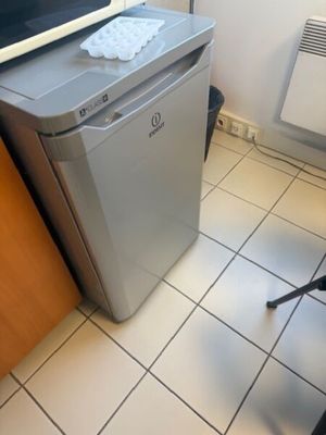 a microwave sitting on top of a refrigerator in a kitchen