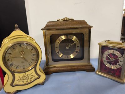 trois horloges posées les unes à côté des autres sur une table
