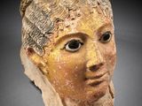 a close up of a clay head of a woman