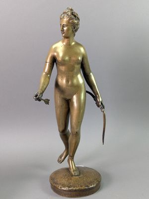 bronze statue of a woman holding a knife and a knife in her hand