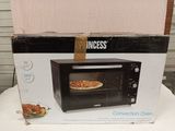 packaging of a black and white microwave sitting on a white table