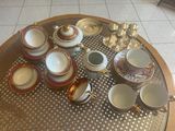 a table that has a lot of cups and saucers on it