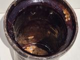 an image of a dirty metal cup on a table
