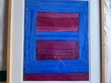 someone is holding a picture of a blue and pink painting