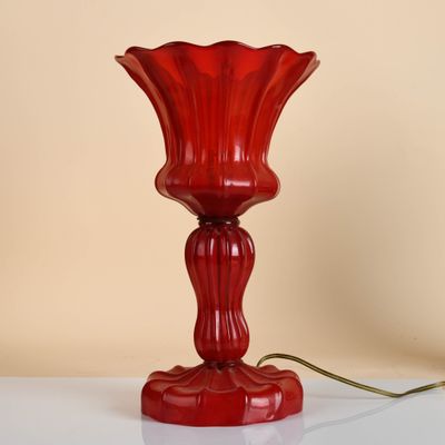 a red lamp that is sitting on a white table