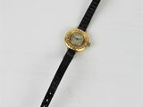 a close up of a wrist watch on a white surface