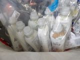 a bag full of bottles and toothbrushes sitting on a bed