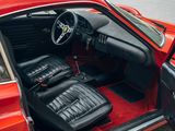 the interior of a red car with black leather seats and a steering wheel
