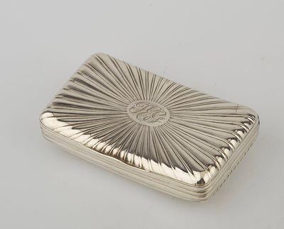 an antique silver cigarette case with a sunburst design on the front