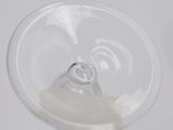 a glass with a liquid inside of it on a table
