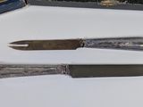 three different types of knives on a table