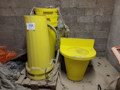 a yellow bucket and a yellow toilet in a room