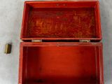 a red box with a painting on it sitting on the floor